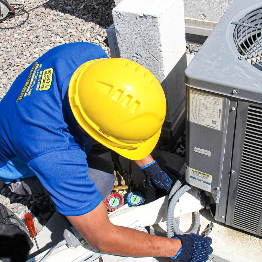 Technician cleaning dirty AC coil