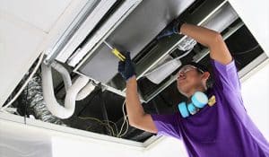 A professional cleaning AC ducts