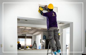 Technician cleaning the AC