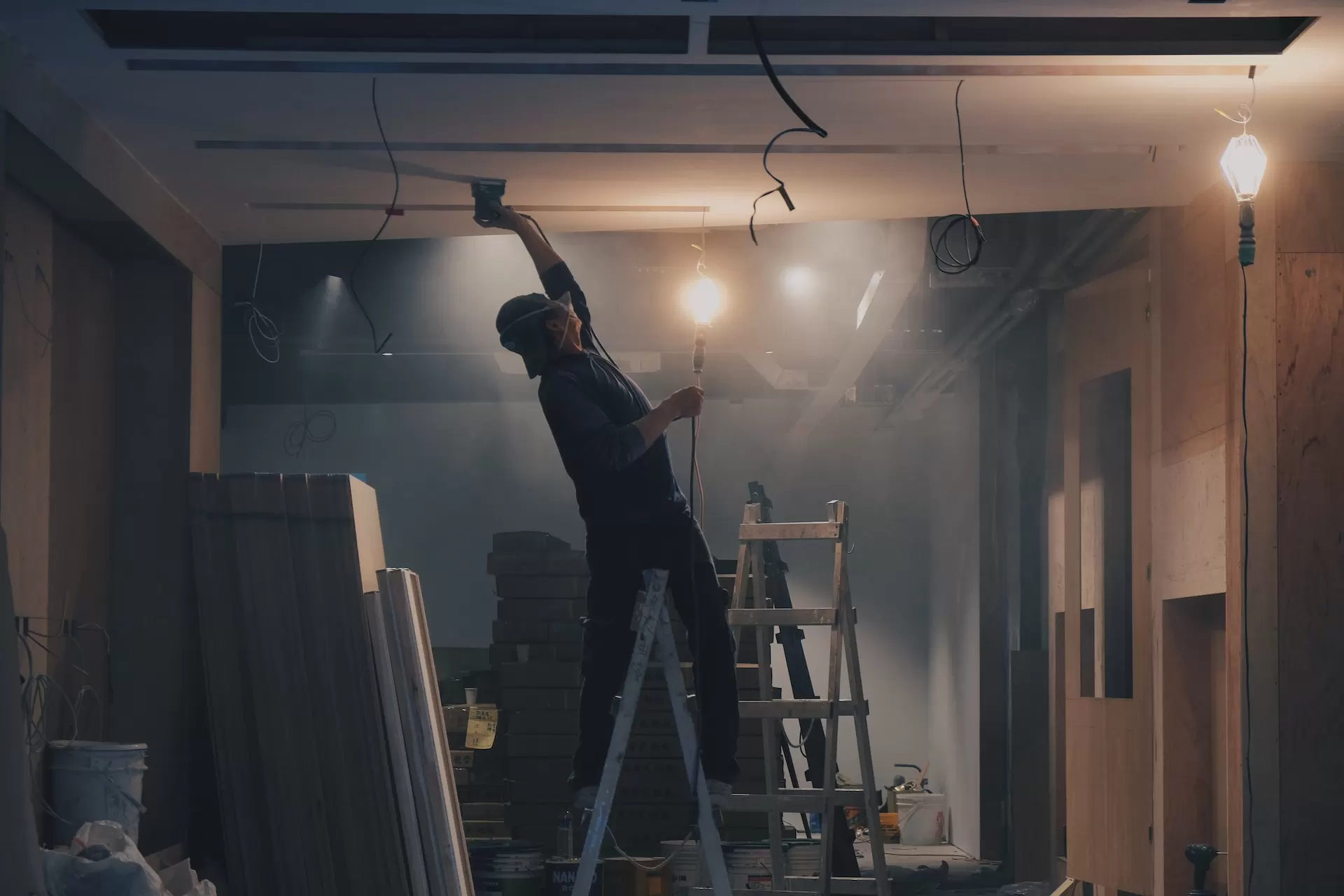 Technician working on the ceiling at night