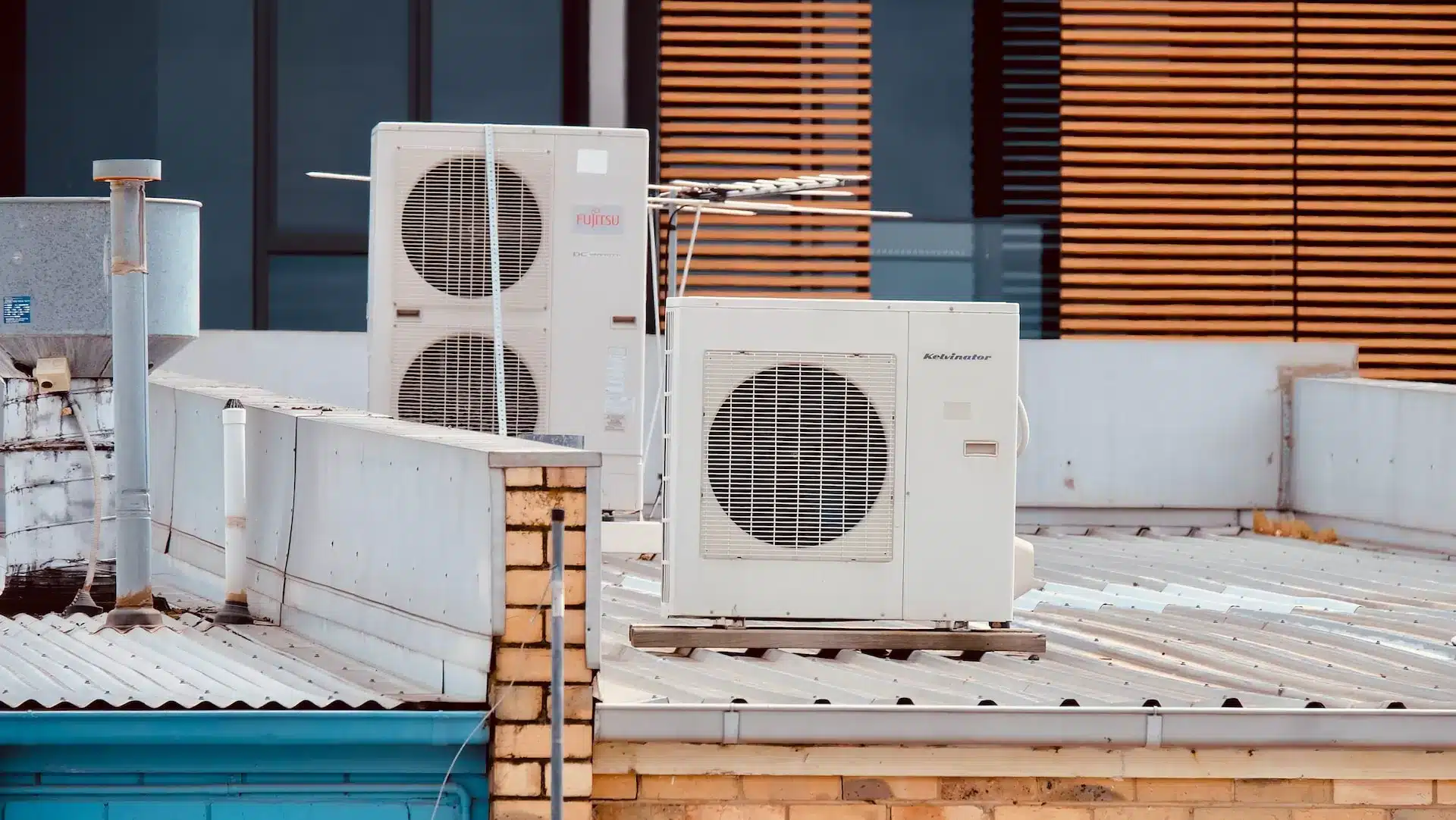 Two AC units placed on a metal sheet